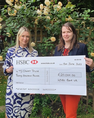 Two women holding a cheque