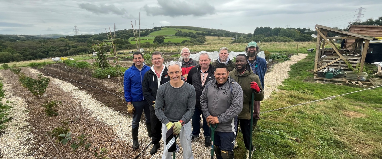 Image shows a group of men in a field