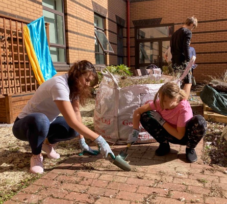 Image shows people clearing a courtyard