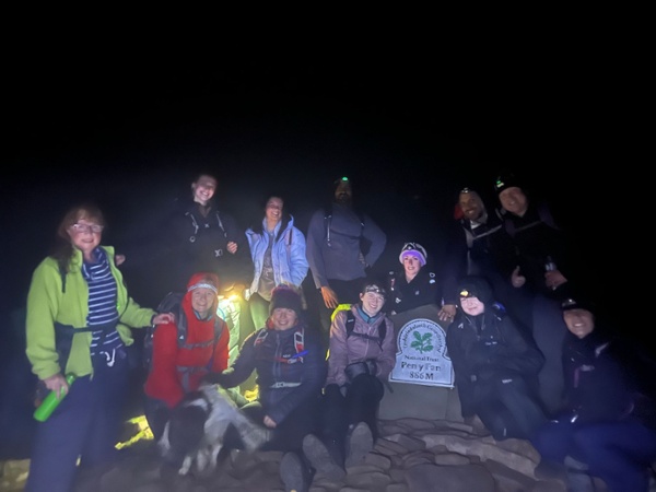 Staff at the top of Pen y Fan in the dark