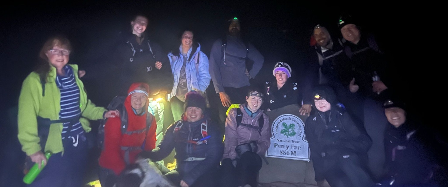 Staff at the top of Pen y Fan in the dark