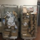 Image shows two metal cages full of Amazon parcels.