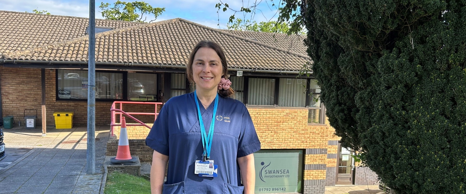 Rachel stood next to a tree outside a GP practice