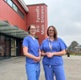 Image shows two women standing outside a hospital