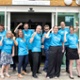 Image shows a group of people standing outside a hospital building.