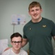 Rugby player Jac Morgan stands next to Gethin Williams, who is wearing a hospital gown.