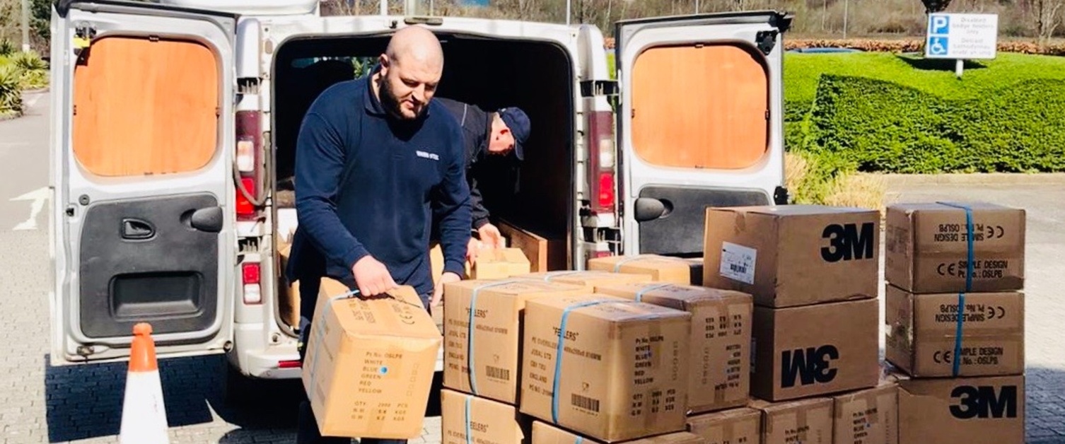 Man unloading equipment out of van