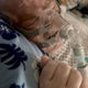 Leighton pictured in hospital bed with oxygen mask covering his face