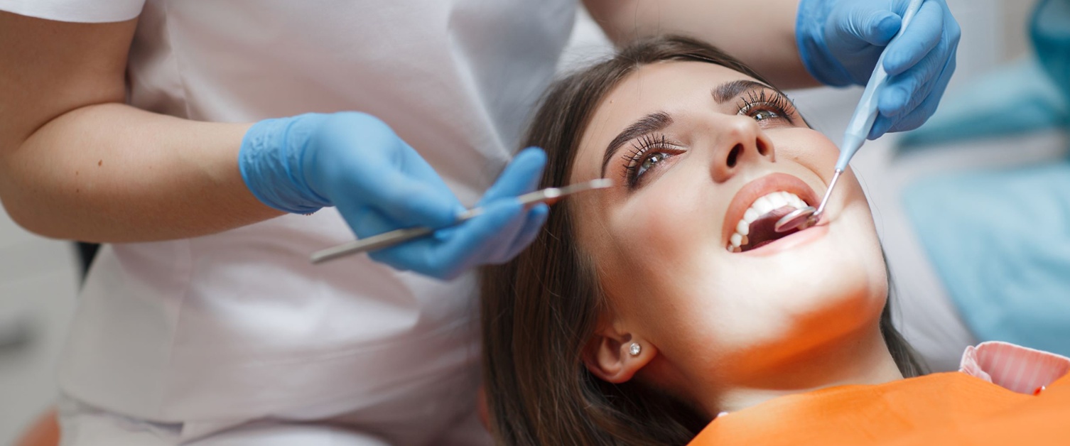 A woman having her teeth examined at a dental practice