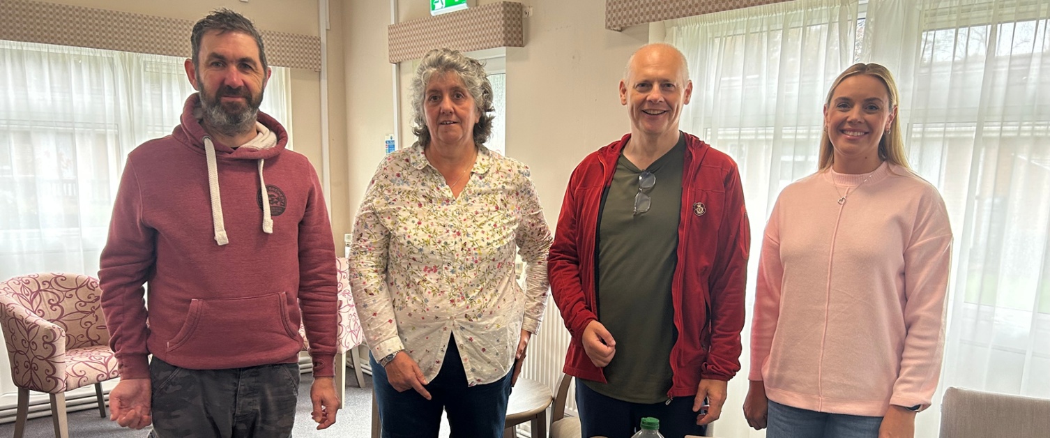 Nick, Julie, Alan and Emma stood in front of a table with vegetables