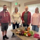 Nick, Julie, Alan and Emma stood in front of a table with vegetables