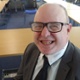 Image is of a smiling man looking into the camera.