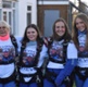 Image shows four women wearing skydiving equipment