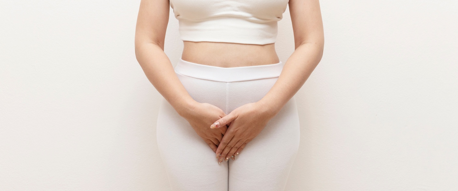A woman holding her pelvic area
