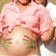 Hand prints in paint on pregnant woman