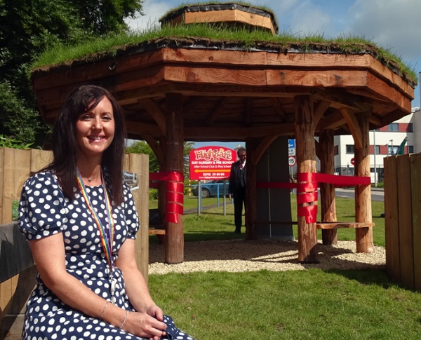 Women sitting outside a wooden roundhouse