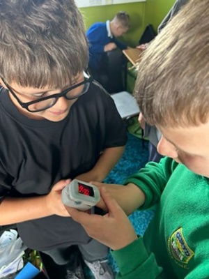 Image shows children looking at a medical device