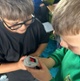 Image shows children looking at a medical device
