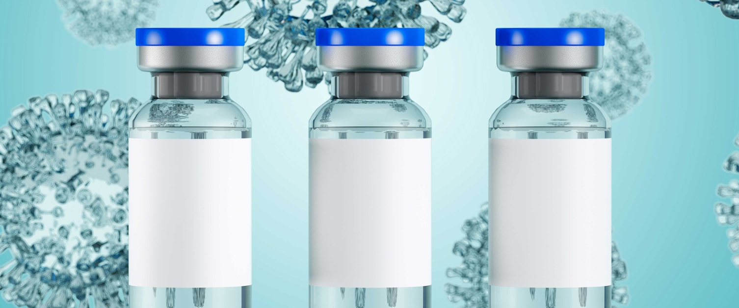 Three Covid vaccine vials in a row against a blue background.