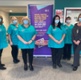 A group of women wearing scrubs standing in a hospital reception
