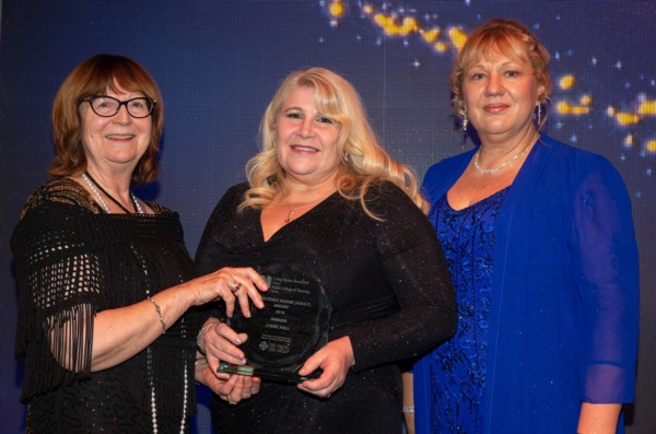 Lynne Hall stands with two other ladies as she holds her RCN award.