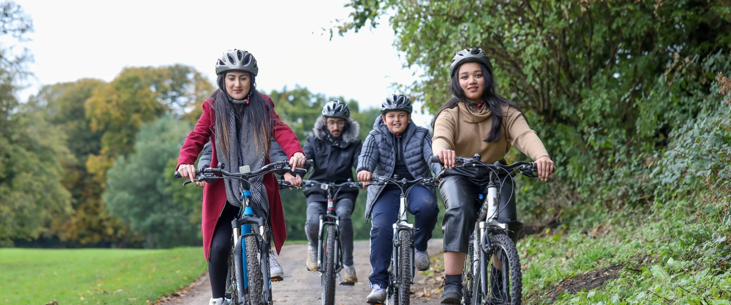 An image of four young people cycling.