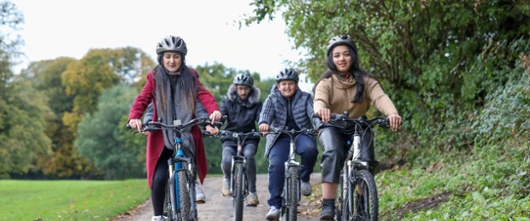 An image of four young people cycling.