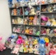 Image shows shelves full of knitted toys.