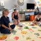 Natasha sat with some mums and babies on a mat