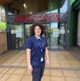 Image shows a woman standing outside
