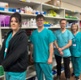 Image shows medical staff standing in front of a medication cabinet