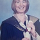 Image shows a woman with a certificate