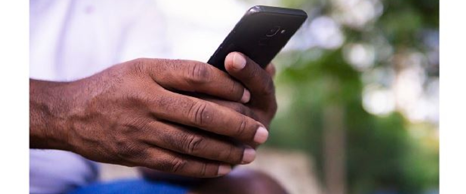 An image of hands holding a phone