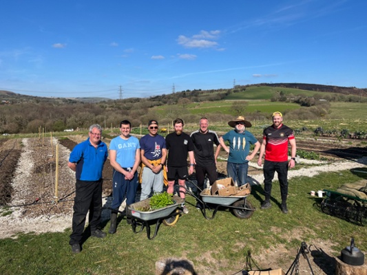 Image shows a group of men in a field