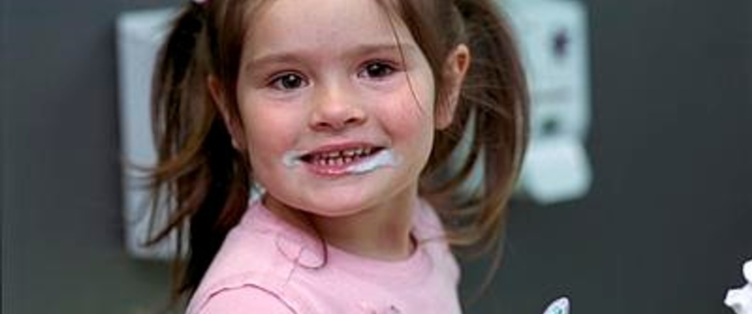 A young girl smiling at the camera