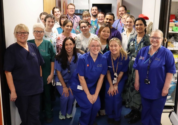 Image shows a group of hospital staff on a ward.