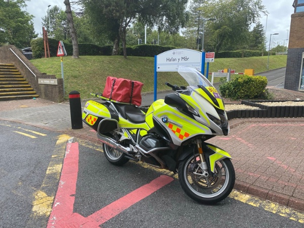 A motorbike parked outside a hospital