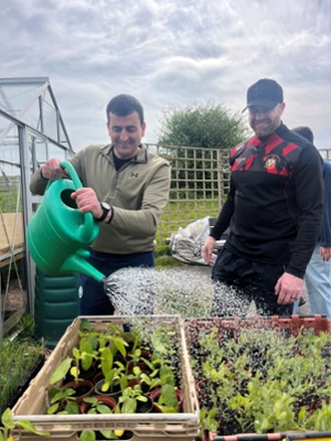 Image shows a man watering plants&nbsp;