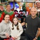 Image shows people dressed as elves with a young hospital patient.