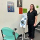 Dr Burge-Jones stood next to the machine and a chair