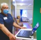 Nurse in a hospital ward using a laptop