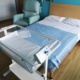 Double bed in the birth centre with cot at end.