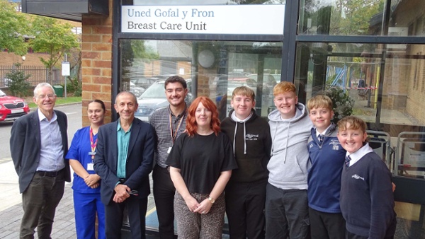Image shows a group of people outside a hospital breast care unit.