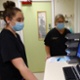 Image shows two staff members looking at diagnostic screens