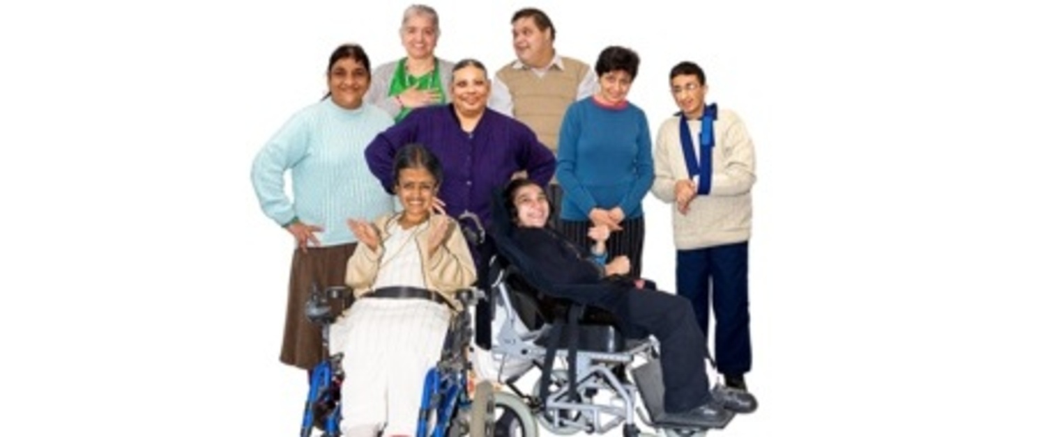 A group of people standing/sitting smiling at the camera