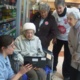 A group of older women and a nurse looking at a laptop screen
