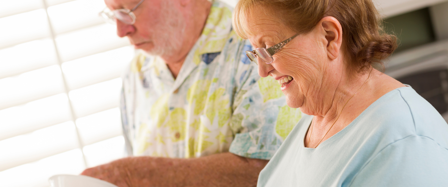 Image shows a man and woman doing the washing up.