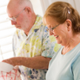 Image shows a man and woman doing the washing up.