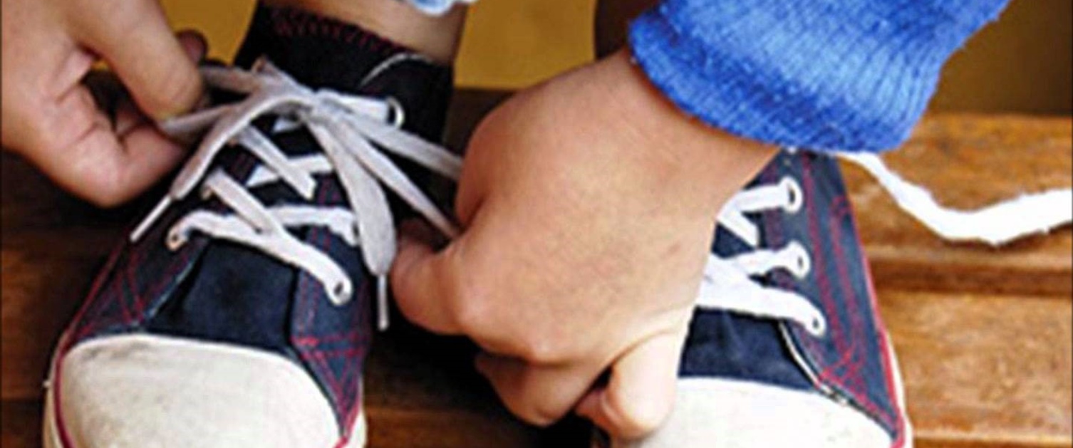 A person tying up their trainers