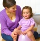 A mother helping her daughter with potty training